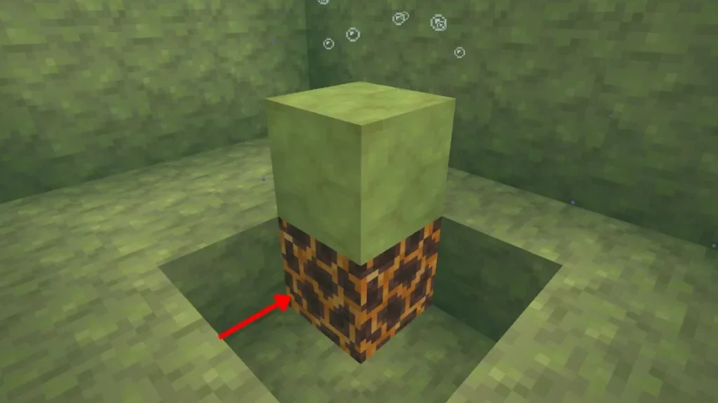Bloque de Azufre Potente sobre bloque de magma en Minecraft con flecha roja señalando la base Bloque de Azufre Potente sobre bloque de magma en Minecraft con flecha roja señalando la base